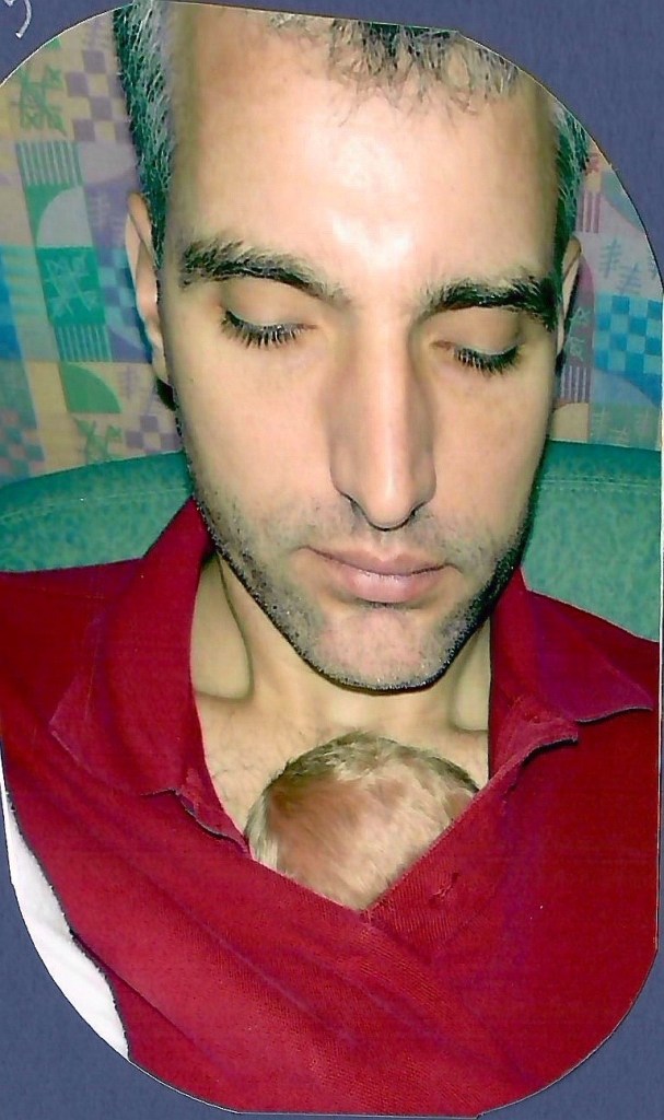 A picture of Eric's dad, Mike, holding Eric in the kangaroo hold position. Eric is all curled up and tucked under Mike's shirt. Eric's head is barely visible sticking out of the top of his Dad's shirt.