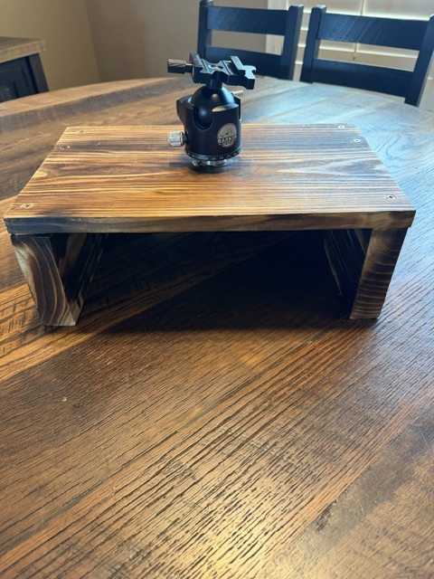 The image shows a wooden box like structure with a Barker Outdoors BOG Ballhead Adapter Attached to the top.